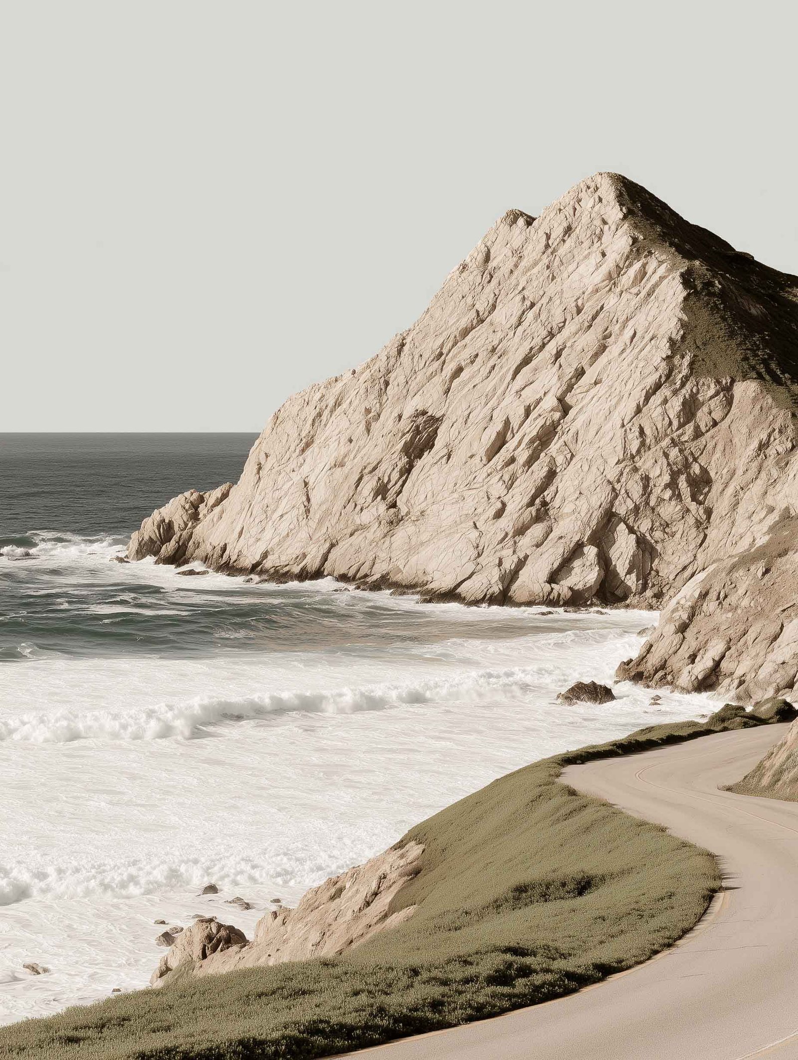 poster of a winding coastal road at sunset
