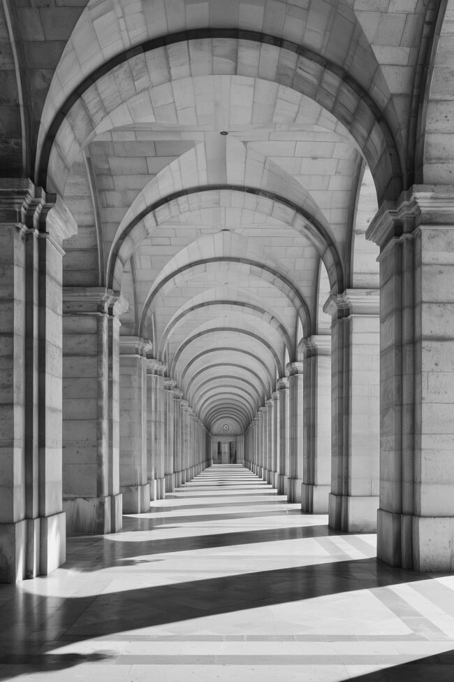 poster of repeating stone arches in monochrome