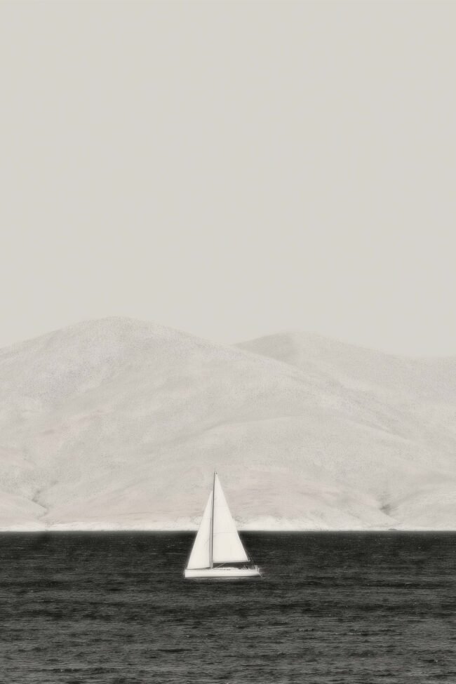 black and white seascape with a sailboat