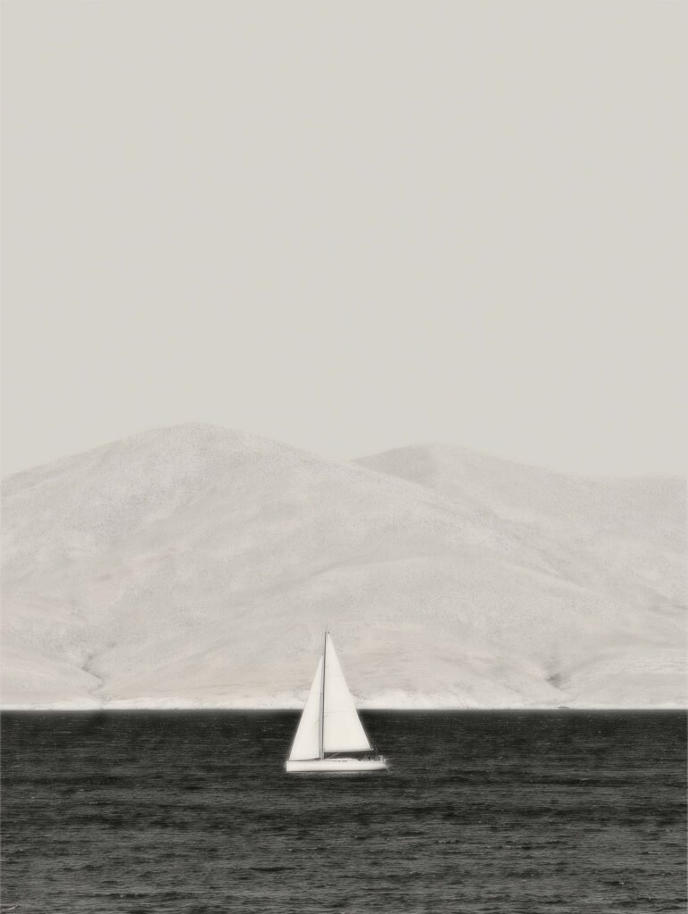 black and white seascape with a sailboat